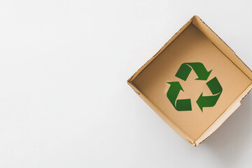 a green recycle symbol on paper box Isolated on white background ,generative ai