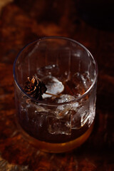 cut crystal old fashioned glass with ice, pinecone
