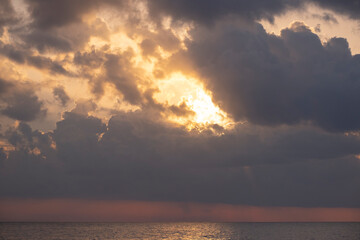 Sunlight filtering through the clouds over the sea