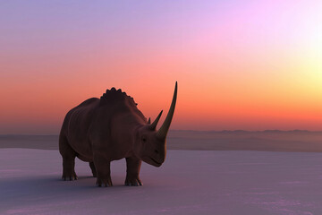 Fototapeta premium A triceratops stands against a colorful sunset in a serene prehistoric landscape