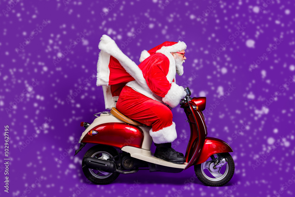 Wall mural Photo of fat santa role man rushing newyear theme party by bike private presents courier wear sun specs and red x-mas costume isolated purple background