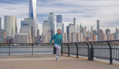 Hispanic Man runner in sport outfit run in NYC. Motion, healthy run. Jogger run near Manhattan downtown. Muscular athlete sportsman run in city. Running sportswear. Handsome guy running workout
