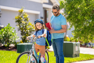 active son kid and father duo cycling through scenic countryside on bicycle. father teaching his son to ride a bicycle. father and son outdoor. father and son enjoying a bicycle ride together