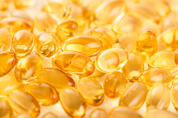 Close up. Cod liver oil capsules with omega 3 and vitamin  texture background.
