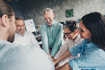 Fototapeta premium Photo of teamwork startup partners teambuilding hold hands comfortable nice creative startup office loft room interior