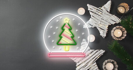 Image of snow globe over christmas decorations