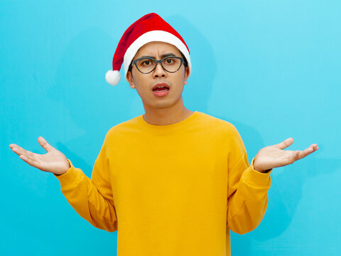 A man wearing christmas hat with shocked face expression.