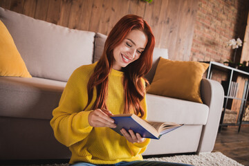 Photo of pretty young woman enjoy read book wear yellow pullover loft interior apartment indoors