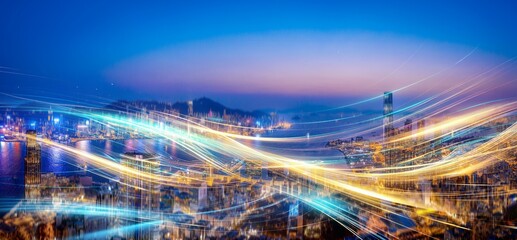 An aerial view of a city skyline at night with abstract light trails.