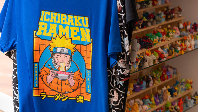 Budokan Geek Convention In GUAYAQUIL, ECUADOR - 
OCT 13, 2024 - A blue Naruto-themed t-shirt featuring the iconic Ichiraku Ramen design, displayed at a geek merchandise shop.