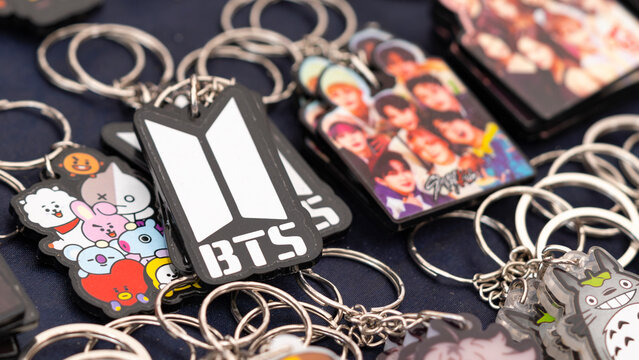 Budokan Geek Convention In GUAYAQUIL, ECUADOR - 
OCT 13, 2024 - Close-up of BTS-themed keychains and other K-pop merchandise on display at a fan booth. 