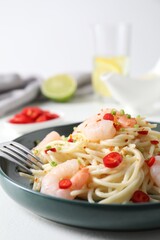 Delicious pasta with shrimps, green onion and chili pepper on white table, closeup