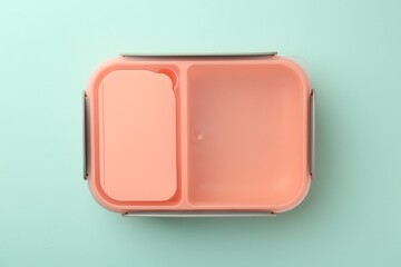 One empty lunch box on light blue background, top view