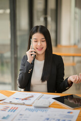 Asian business woman working and talking at the office
