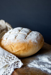 Vertical side view of an artisanal bread ,isolated on black background.