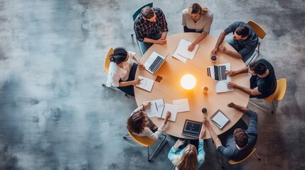 Group of professionals collaborating on a project around a table during a brainstorming session in a modern workspace