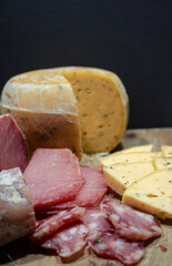 Vertical photo of Selection of artisan cheeses and cold meats.