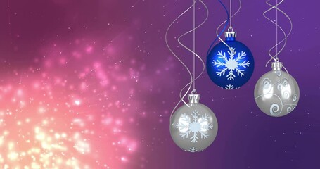 Animation of light spots over christmas baubles - Powered by Adobe