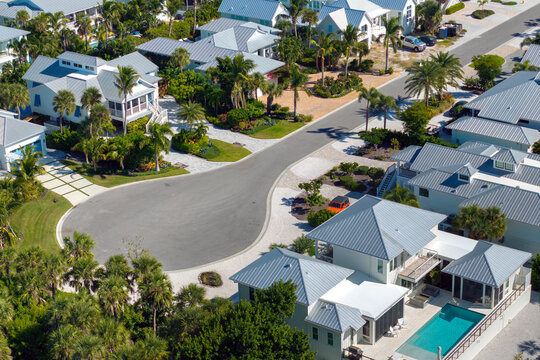 Cul de sac street dead end and private residential houses in rural suburban sprawl area in Boca Grande, Florida. Upscale suburban homes with large waterfront backyards