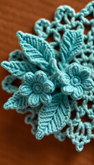 Crocheted teal flowers and leaves close up on crocheted teal pattern and brown background isolated with white highlights, png
