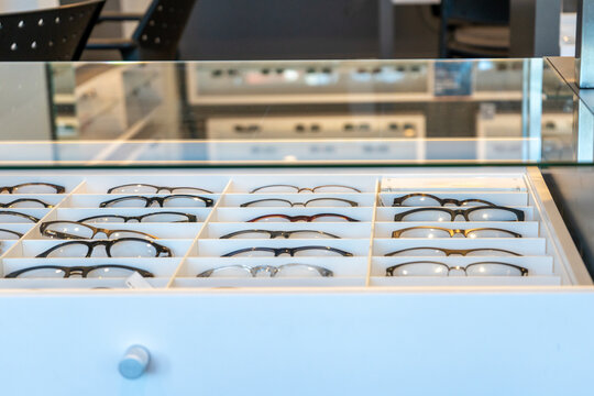 Eyeglasses frames in optometry shop in a drawer shelf for sale, ready for prescription lens orders