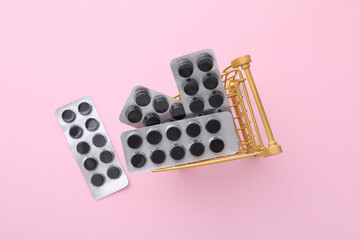 Activated charcoal tablets in a metal basket, top view.