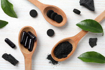Activated charcoal tablets in a spoon, top view.