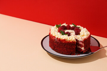 Red velvet cake with berries on plate on red background, space for text