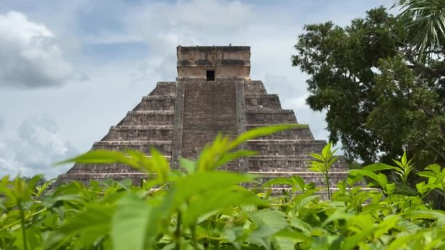 Handheld long lens booming up shot of the Mayan pyramid El Castillo at Chichen Itza in Yucatan, Mexico. 4K