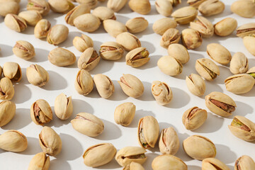Pistachios in the shell, on a light background.