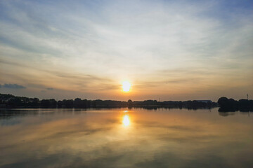 sunrise with reflection in the pool with mangrove forest as the border