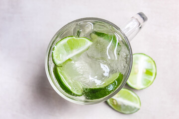 a glass of cold soda water and slices of lime