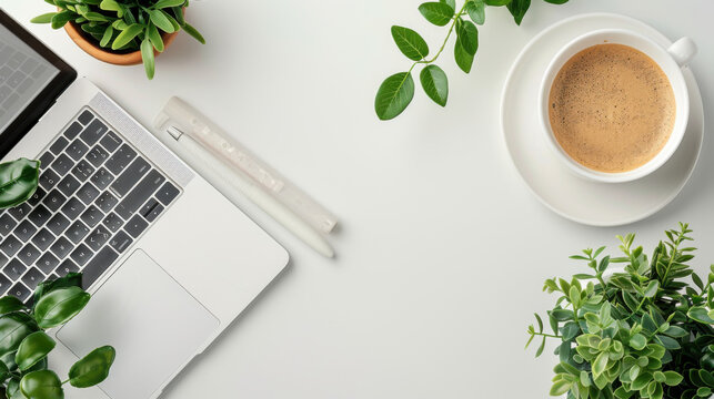 Modern white office desk table with laptop, smartphone and other supplies with cup of coffee. Blank notebook page for input the text in the middle. Top view, flat lay.