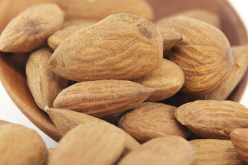 Closeup of raw almonds isolated on a white background