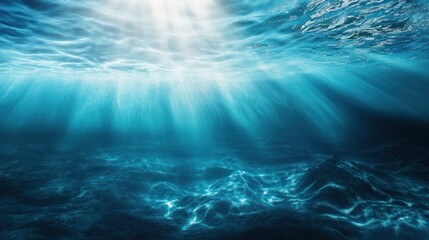 Underwater scene with sun rays shining through the surface of the water, illuminating the sea bed.