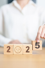 Happy New Year 2025 with Sad face block. Satisfaction, feedback, Review, mental health, eco sustainable and bad year concept