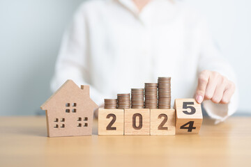 2024 end year to Happy New Year 2025 with house model and Coins stack. real estate, Home loan, tax,...