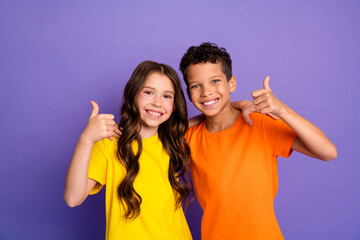 Photo portrait of cute little boy girl thumb up approve dressed stylish yellow orange clothes isolated on purple color background