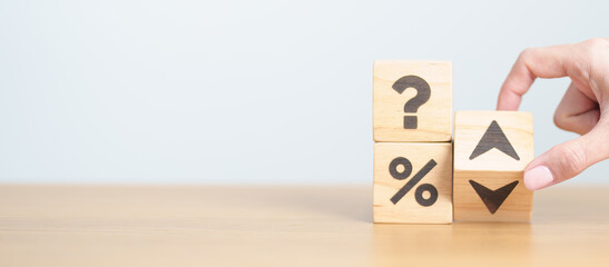 wood block of Question mark with percentage change to UP and Down arrow. Interest rate, GDP, stocks market, financial, deflation and Inflation, ranking, mortgage, debt, Loan and Economic Recession