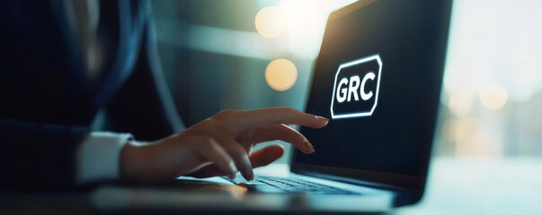 GRC, Governance Risk and Compliance concept, Business person using laptop computer and hand touching GRC icon on vr screen, Risk Management and Compliance procedures and processes