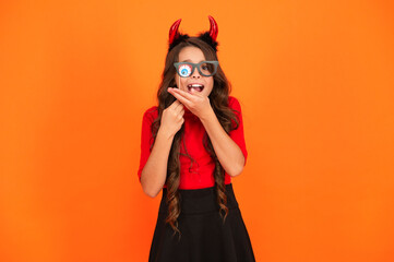 Girl devil ready for Halloween party isolated on orange. Trick or treat. All Hallows party celebration. Hallows funny props. Girl devil has Halloween party props. Happy Halloween. Costume accessory