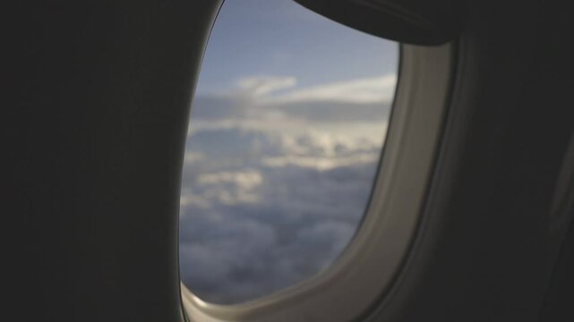 view from an airplane window, beautiful white clouds from above, captured canon eos R, raw c-log 8bits colour.