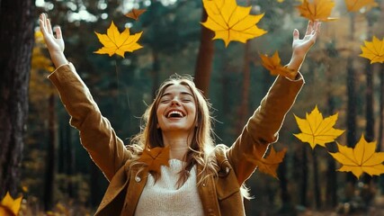 A young woman throwing autumn leaves in the air during a walk through the forest, her face lit with happiness