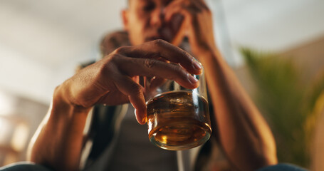 Alcoholic, stress and glass of whiskey with person in living room for substance abuse, risk and...