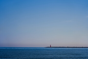 Travelling to the seashore near the lighthouse. Marine vacation in Europe