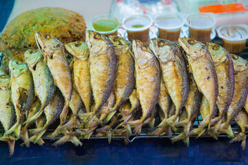 Many fried Short mackerel are beautifully arranged and sold at a street food market in Thailand.