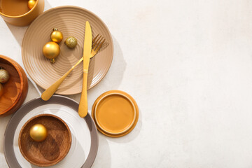 Beautiful table setting with Christmas balls on white background