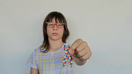 Child hand holding colorful heart concept. World autism awareness day - Powered by Adobe