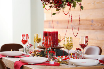 Festive dining table with Christmas setting and beads in room
