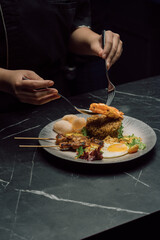 person holding a plate of food